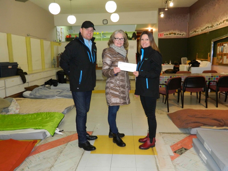 James Yanner, Senior Project Manager (L), and Jennifer Osmar, Senior Advisor, Stakeholder Relations (R) from AltaGas, present a cheque to Executive Director, Christine White from the North Coast Transition Society, to provide support for a new extreme weather shelter
